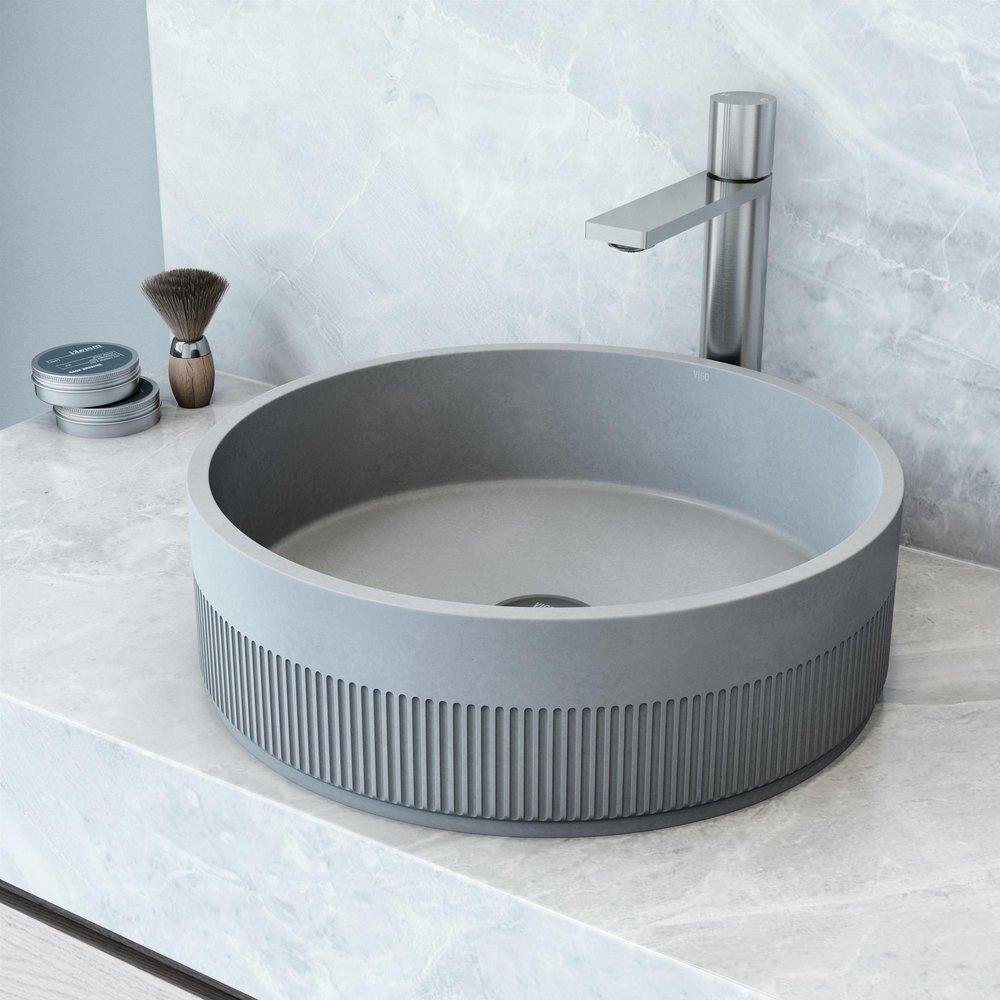 THE CYPRESS CONCRETO STONE ROUND FLUTED BATHROOM VESSEL SINK IS A BREATHTAKING BLEND OF TIMELESS ELEGANCE AND MODERN DESIGN. ITS EXTERIOR REVEALS AN INTRICATE FLUTED DESIGN ADDING A TOUCH OF ARTISTIC 