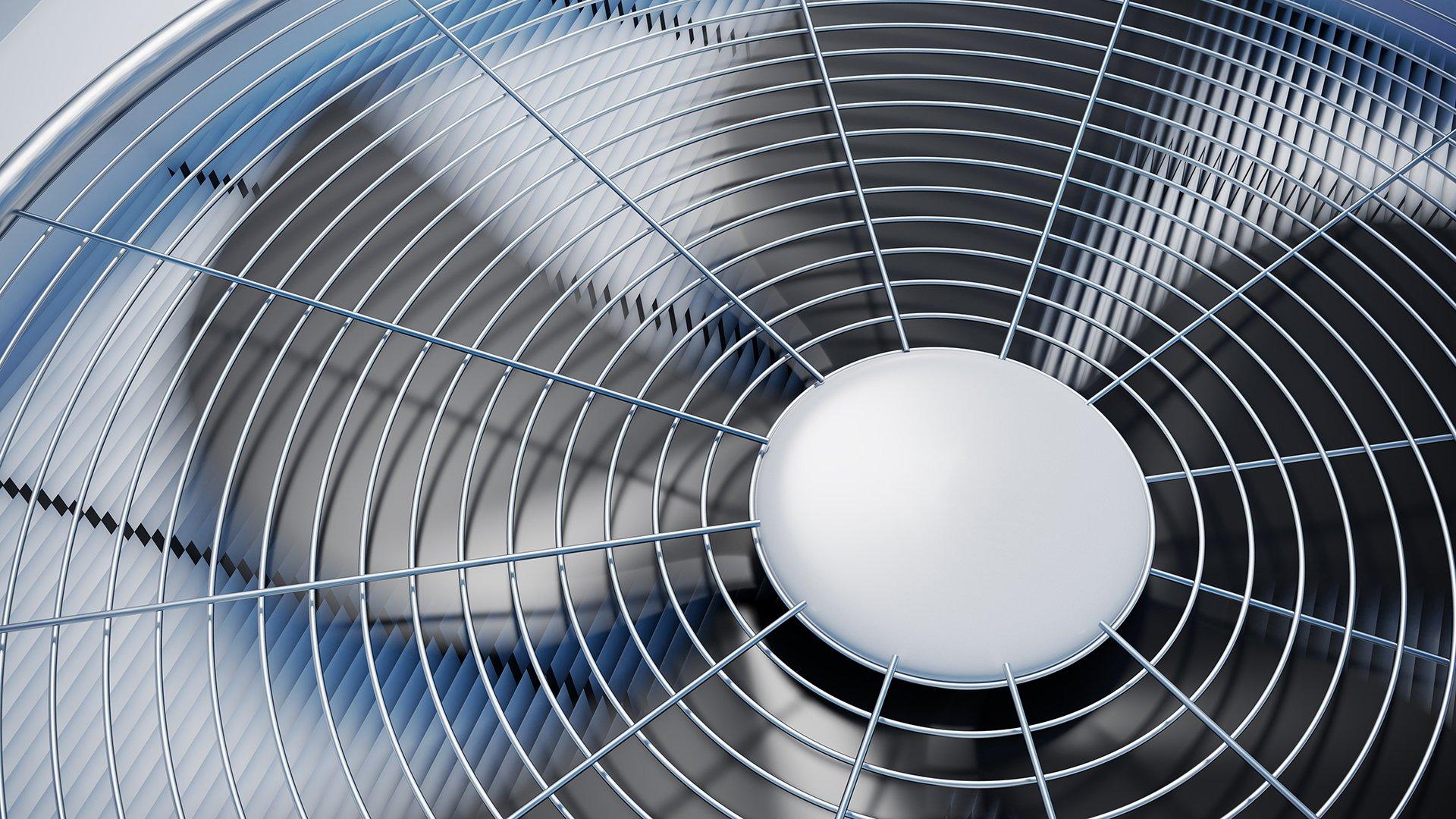 Closeup view of the top of an air conditioner condenser.