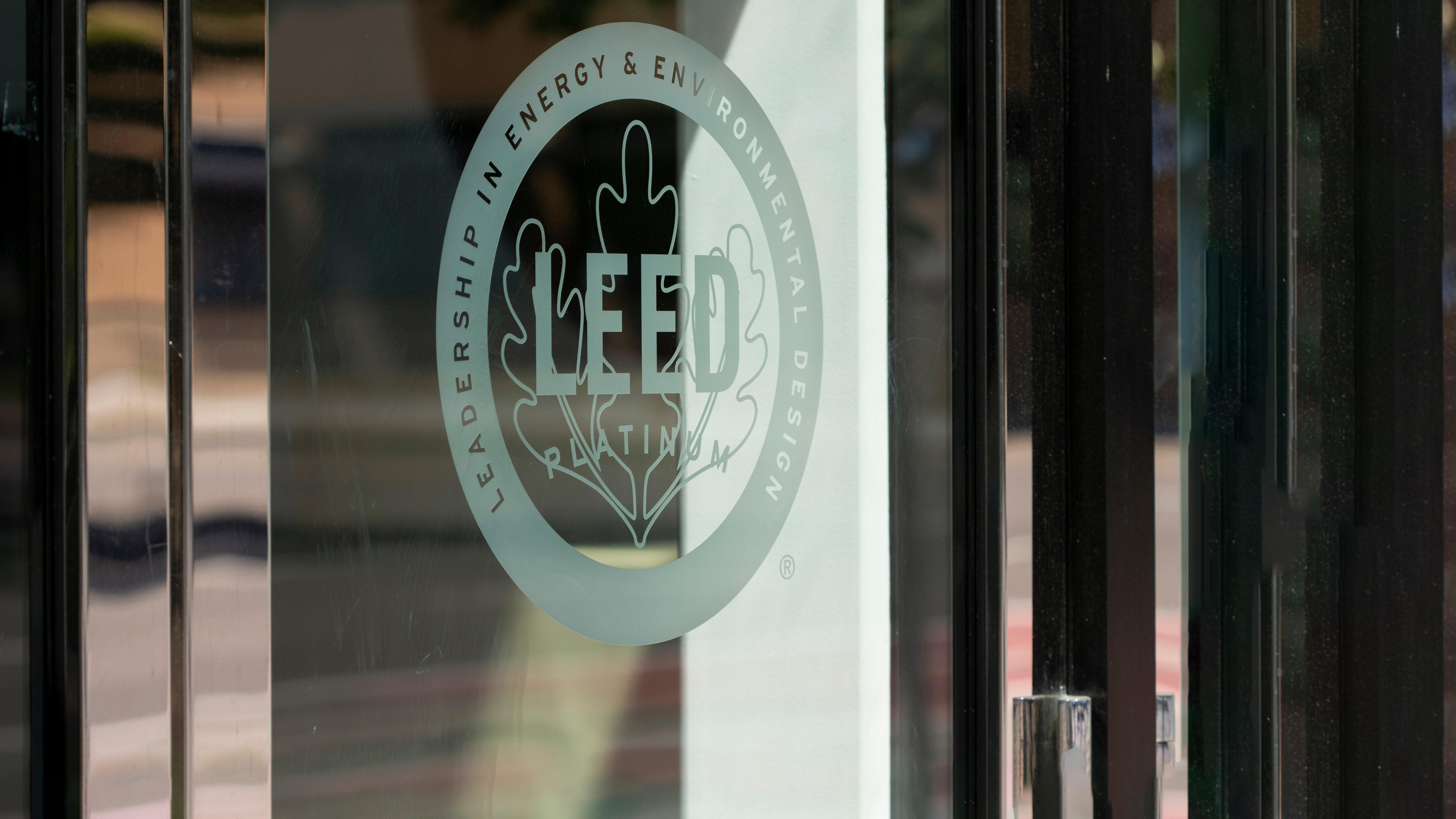 The LEED Platinum certification icon on a glass door.