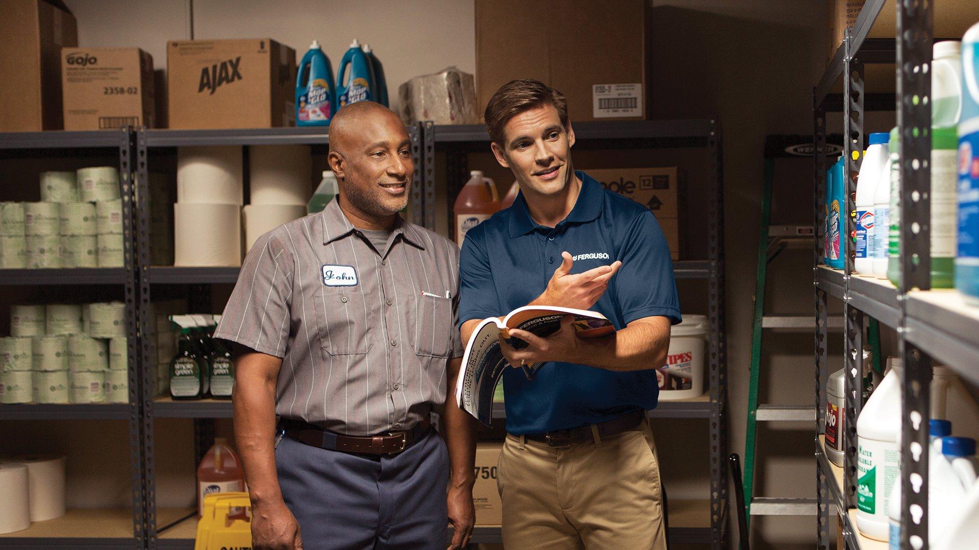 Two men browsing through a large supply closet