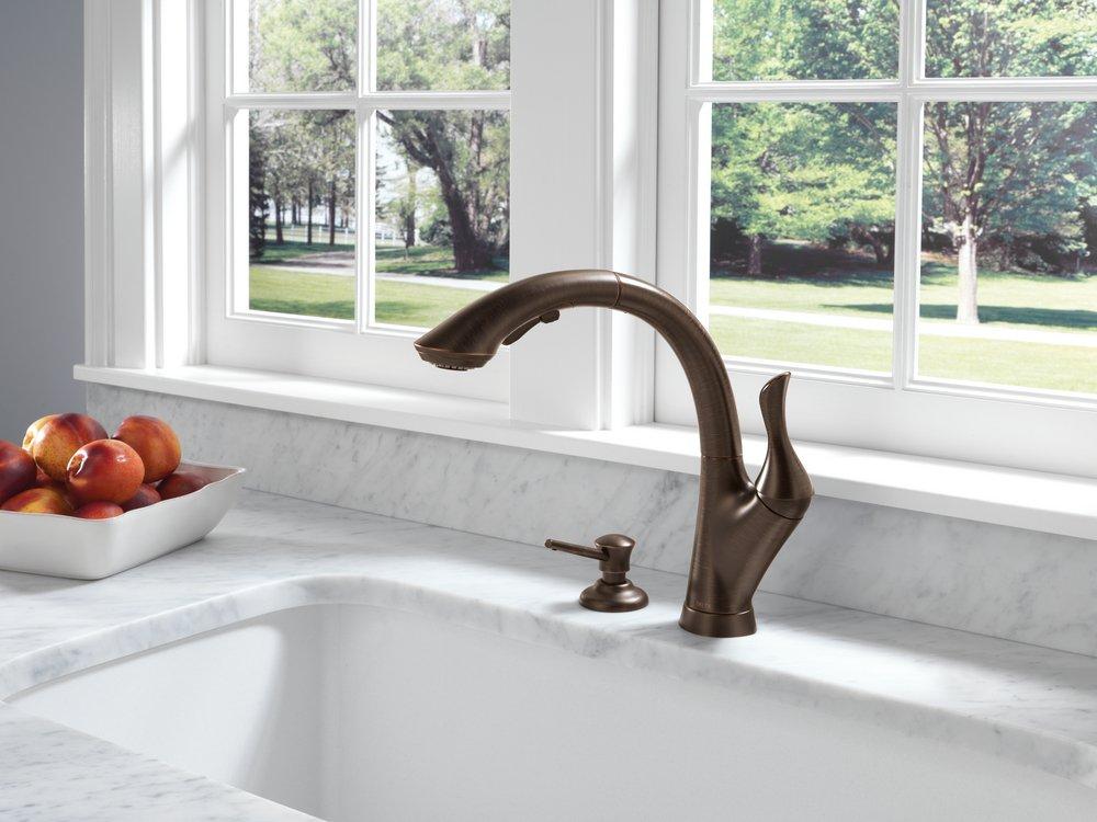 Delta Faucet Champagne Bronze 13 oz. Deck Mount Plastic Soap and Lotion Dispenser 