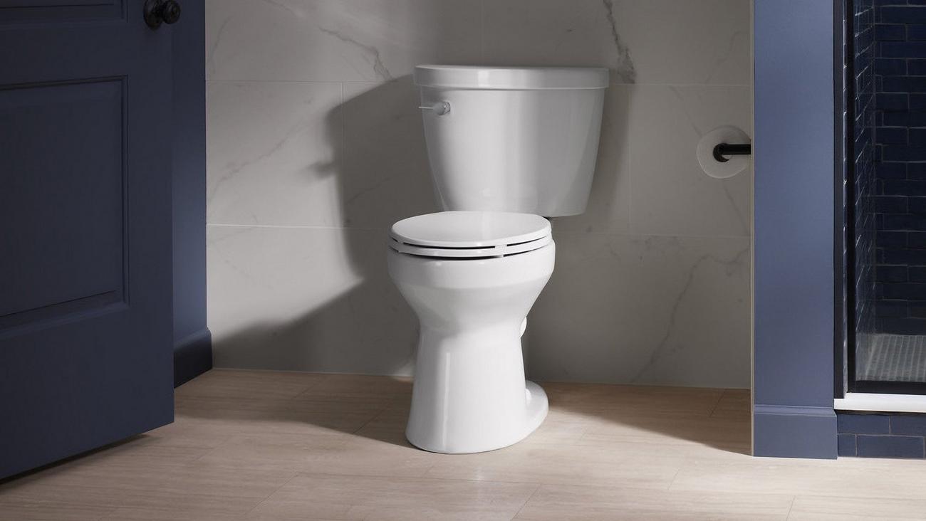 White Kohler toilet installed in residential home. 