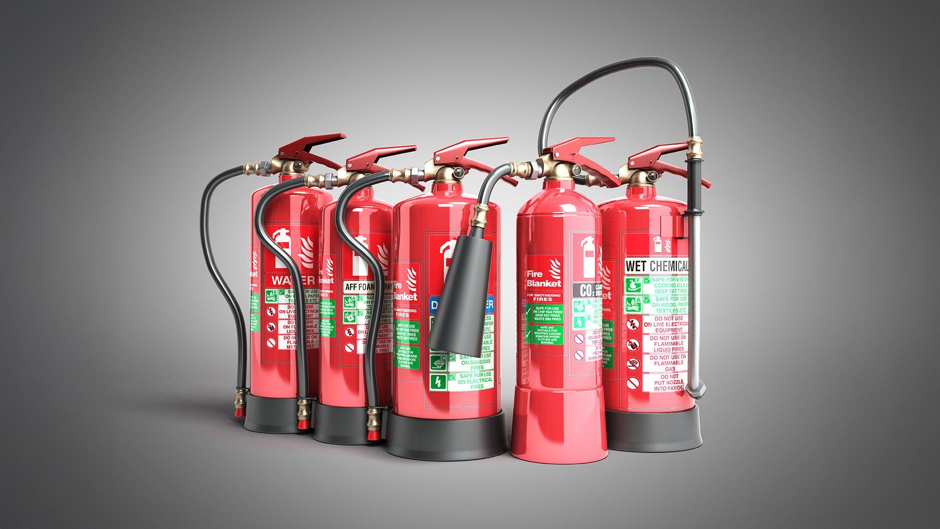 Various types of fire extinguishers isolated on a gray background