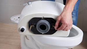 Lifestyle image of drylock installation system on Kohler toilet. 