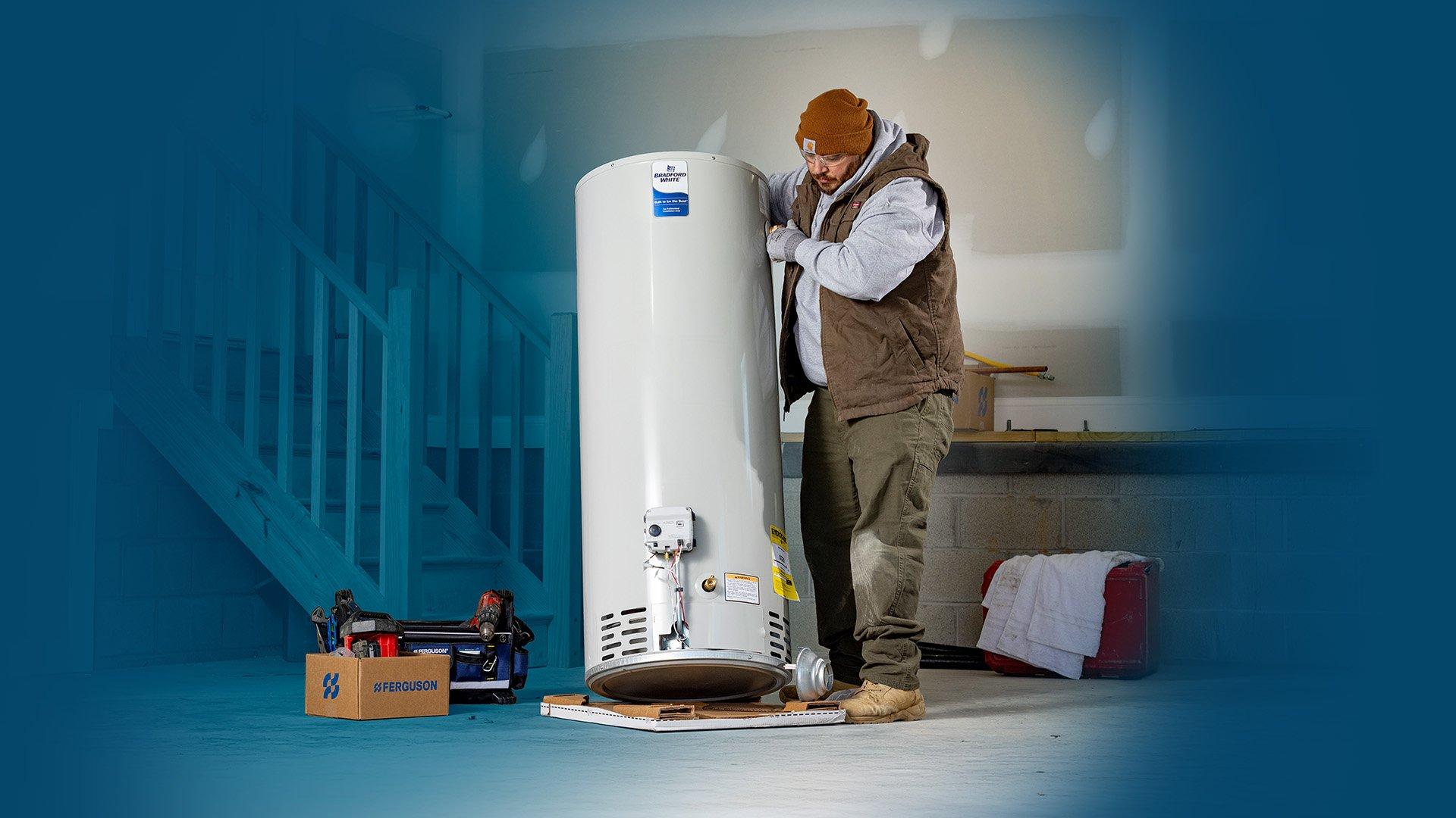 Lifestyle image of contractor installing Bradford White residential water heater in home. 