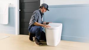 Plumber installing a KOHLER toilet