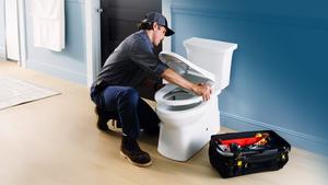 Plumber installing a KOHLER toilet