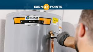Close up image of plumber installing State residential water heater. 
