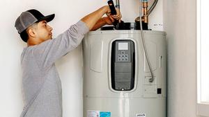 Contractor installs Bradford White residential water heater in home. 