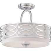 A white, round ceiling light with a silver design laid over it.