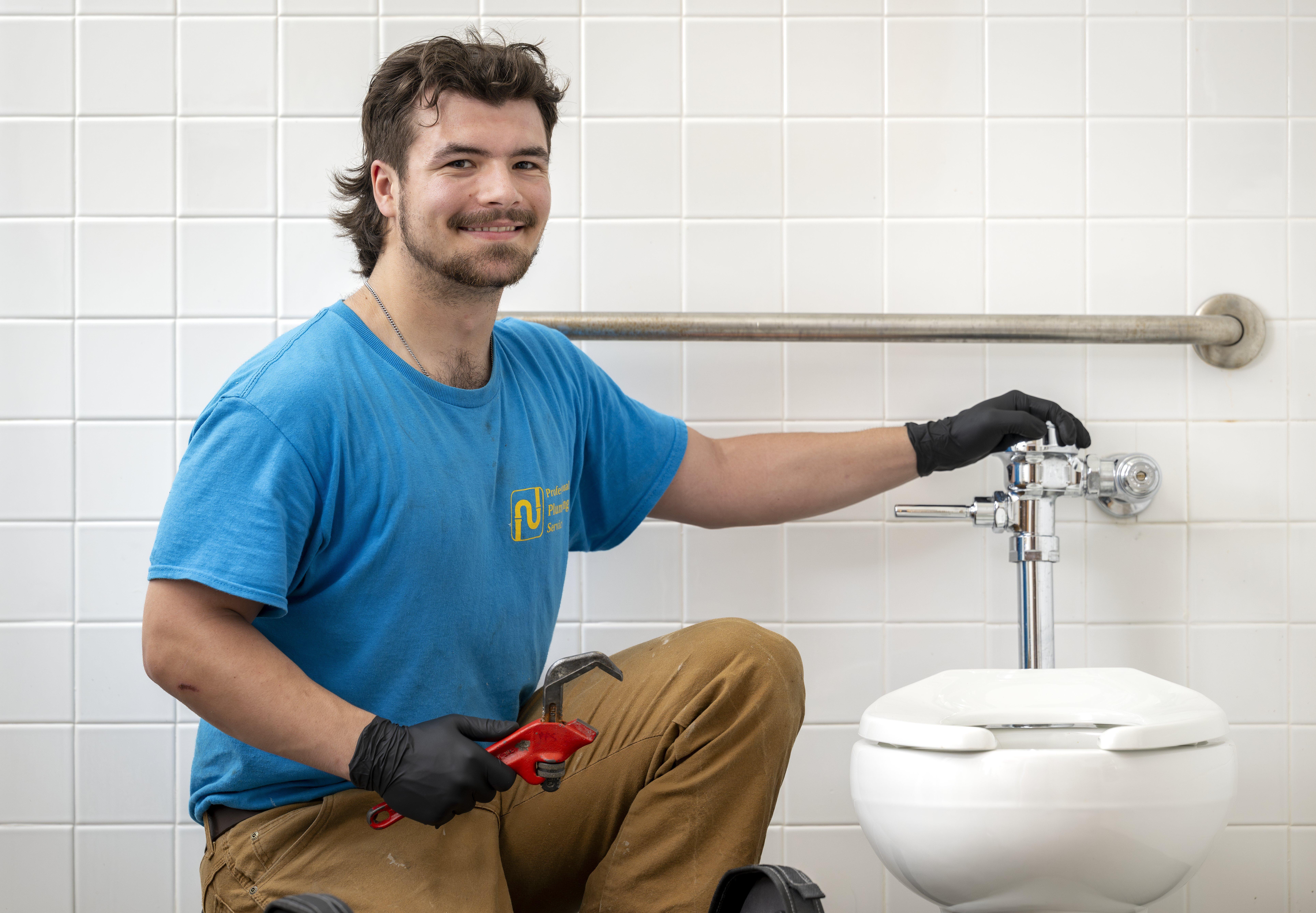 Industry professional; plumber, installing a commercial toilet