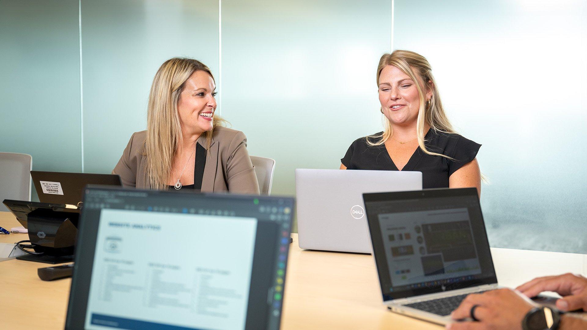 Ferguson associates hold a business meeting at a conference table.