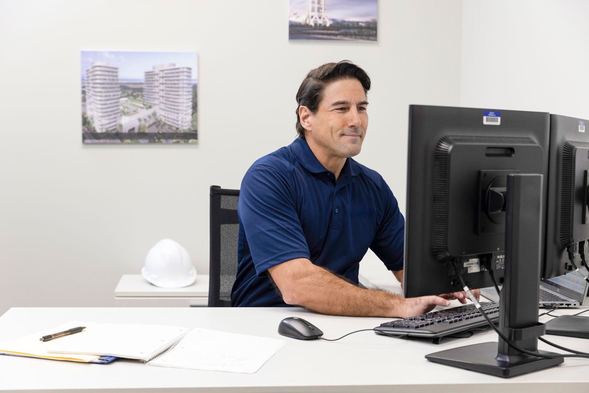 A Ferguson associate types at a computer while sitting at his desk.