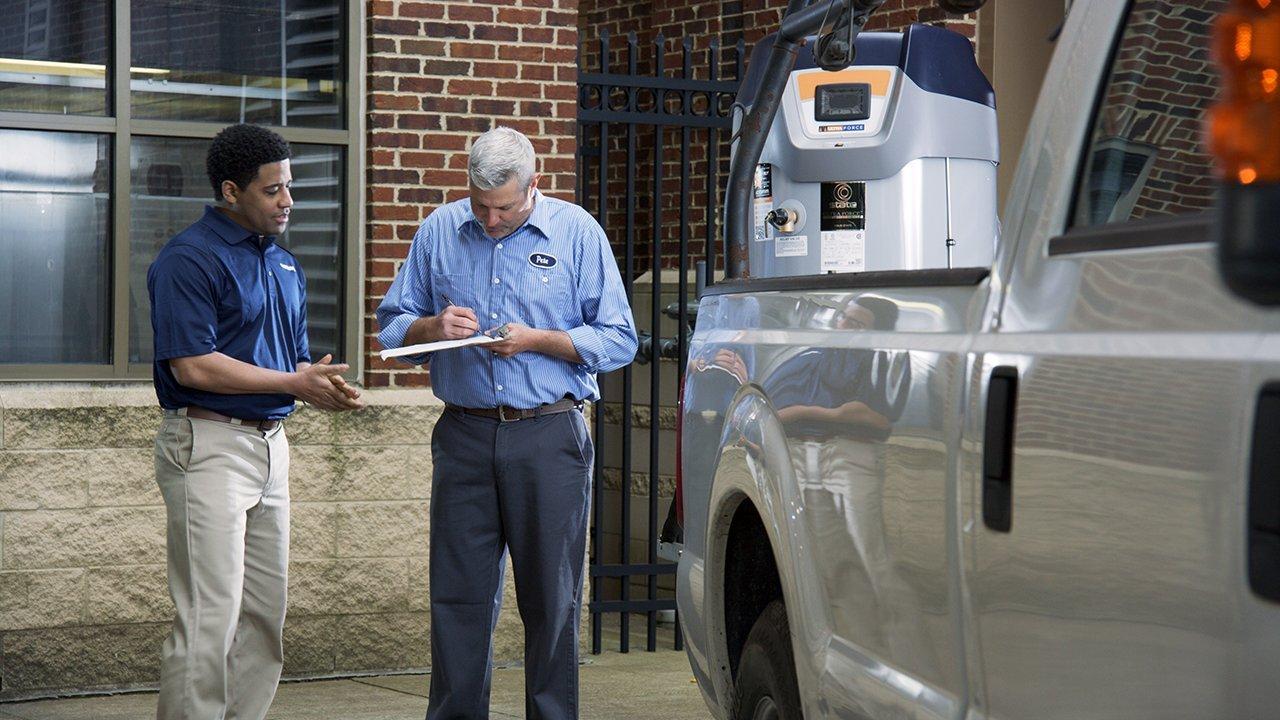 A contractor signs for delivery of a commercial water heater.