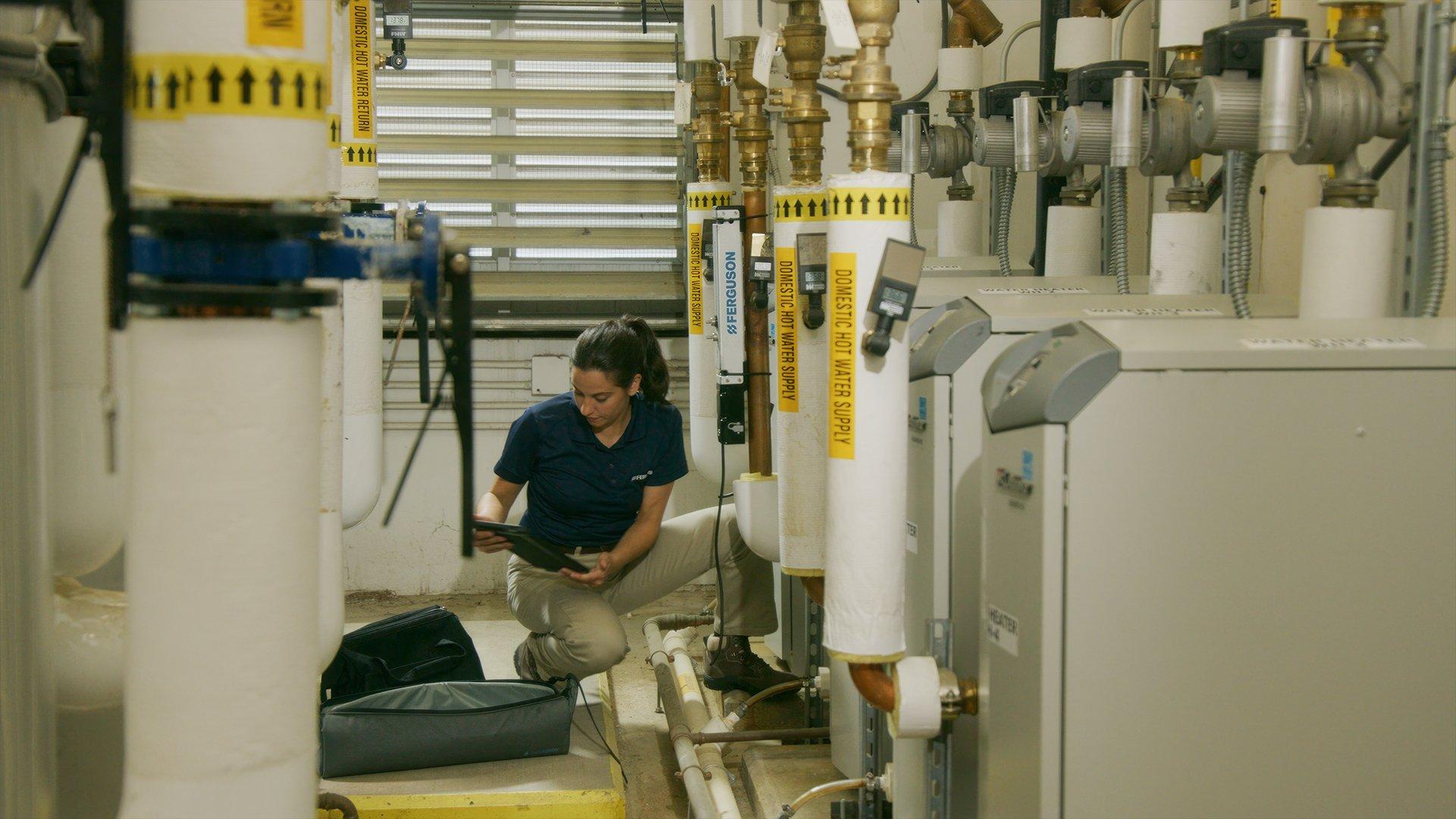 A Ferguson associate conducts a field audit on a building’s water system.