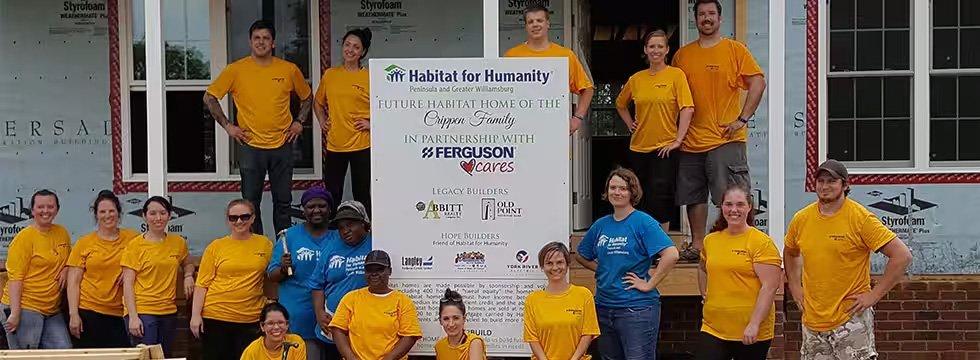 Ferguson volunteers pose in front of a Habitat for Humanity home.