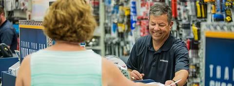 A Ferguson associate helps a customer at a counter location.