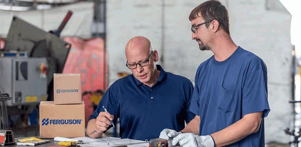 Two Ferguson associates review an order in a warehouse.