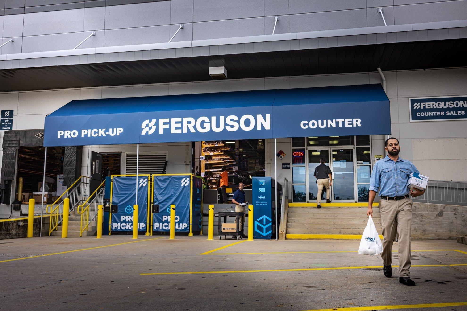 A contractor carries items in a bag while leaving a Ferguson Counter location.