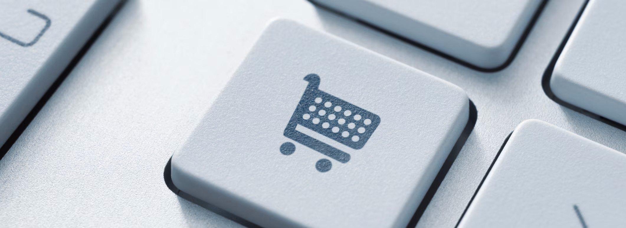 A button on a computer keyboard displays a shopping cart.