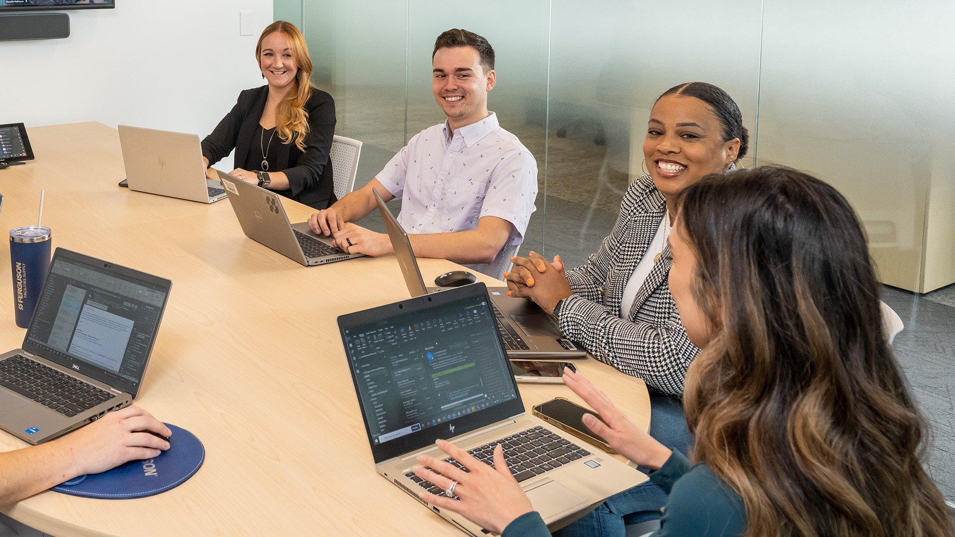 Ferguson employees sit around a conference table to discuss business goals.