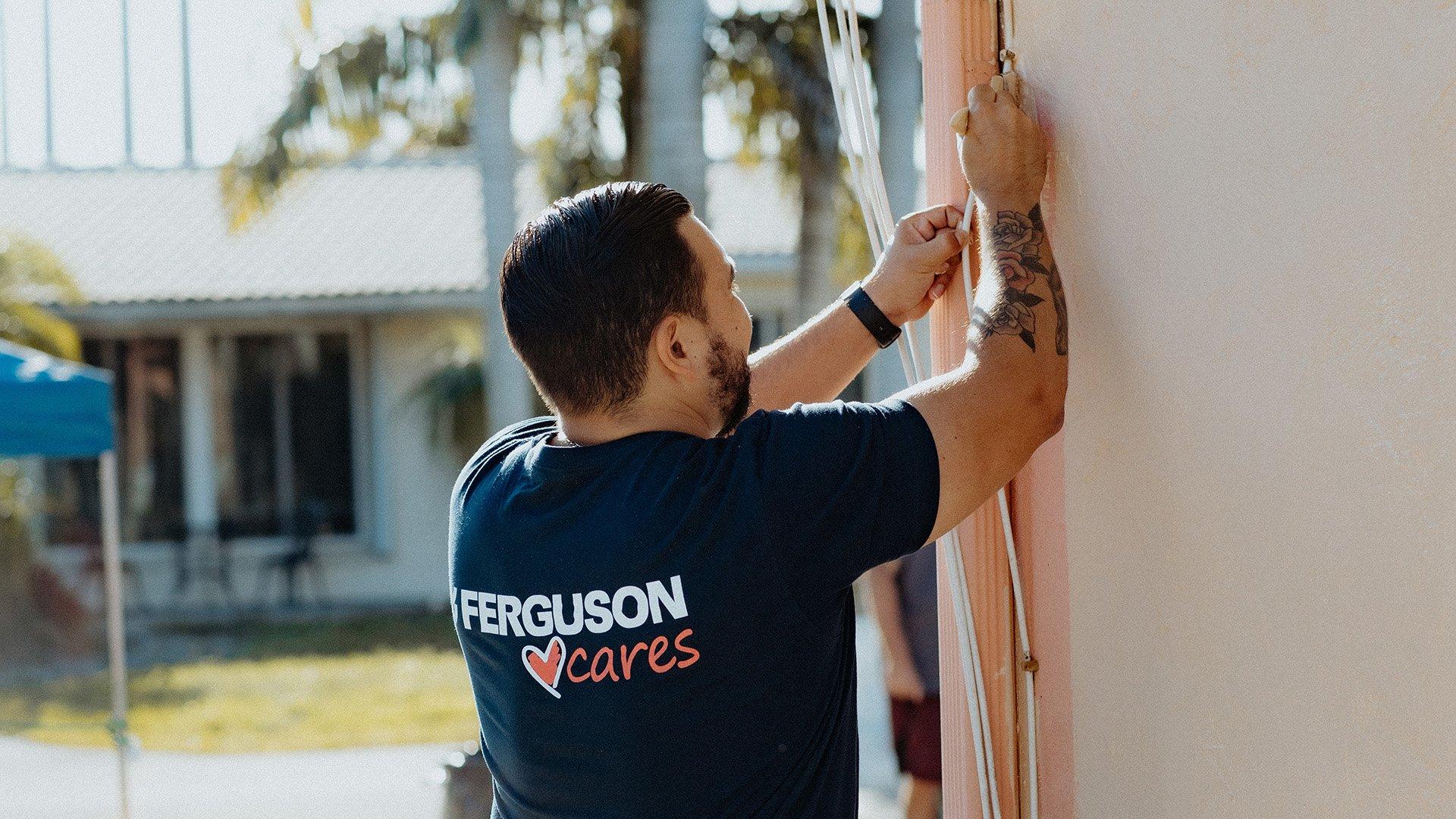 Ferguson employee installs wire on volunteer day.
