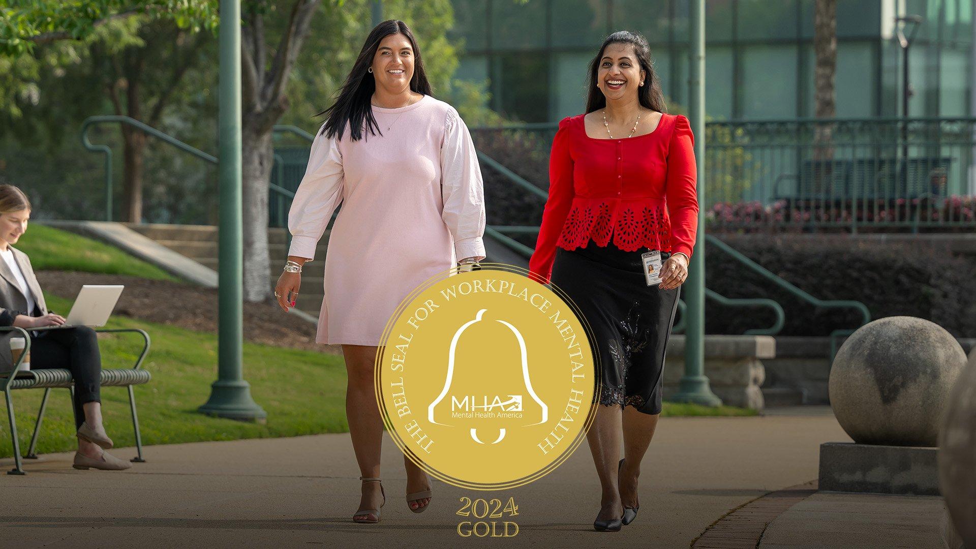 Two Ferguson employees walk outside with Gold Bell Seal overlay.