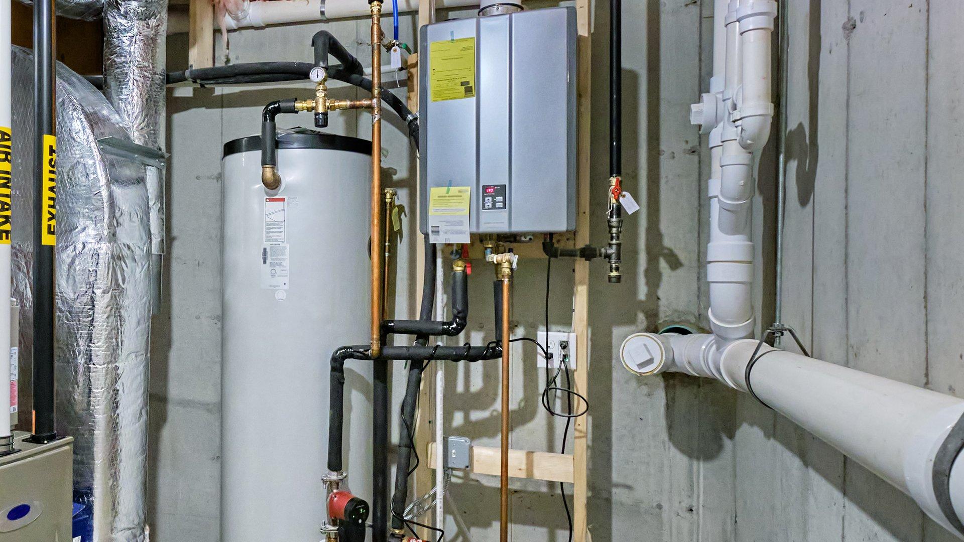 Installed hot water recirculating system within residential home next to water heater and duct work. 