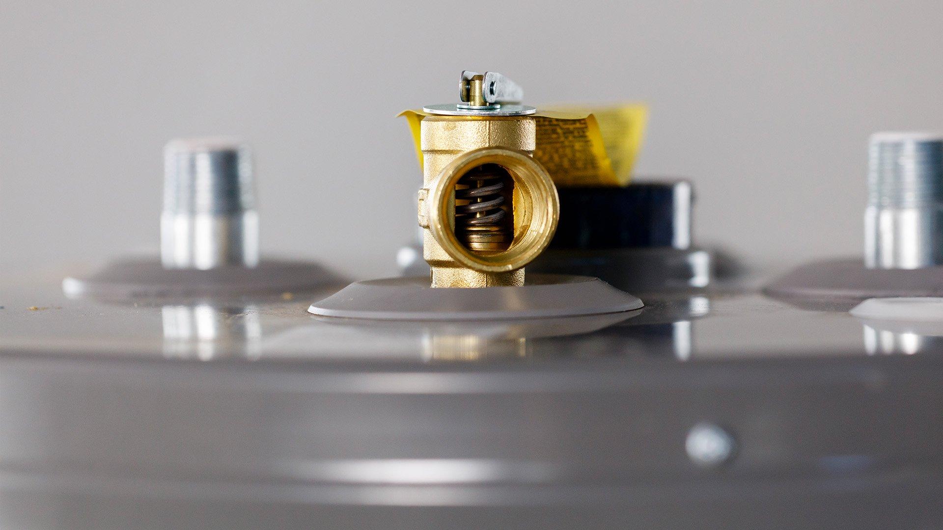 Close up imagery of water heater pressure relief valve.