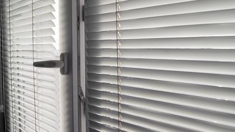 Closeup view of custom cut window blinds hung on a window.