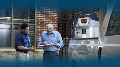 A contractor signs for delivery of a commercial water heater.