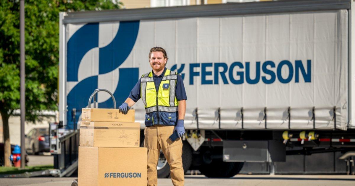 An associate with boxes in from of a delivery truck.