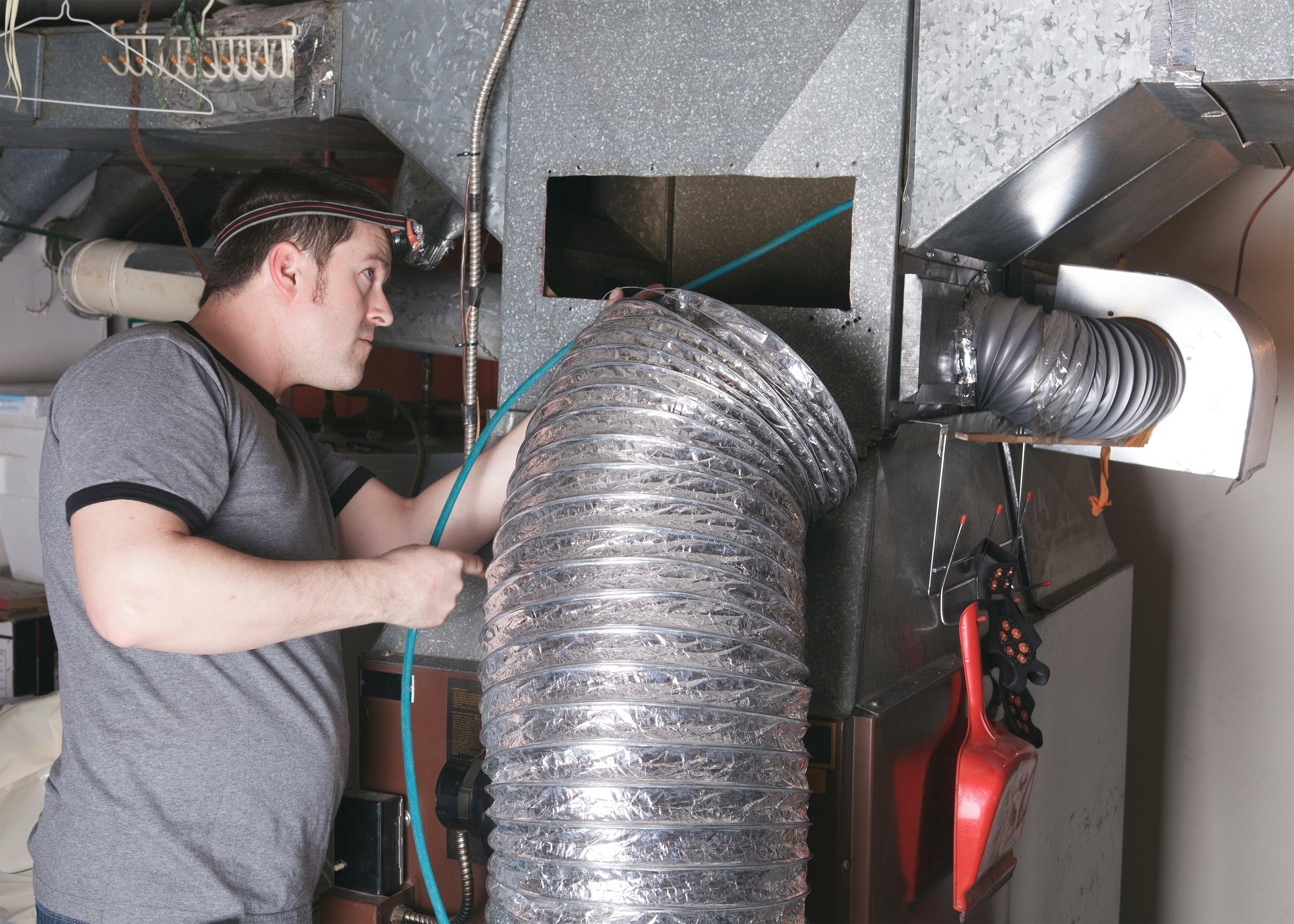 HVAC Tech cleaning a duct