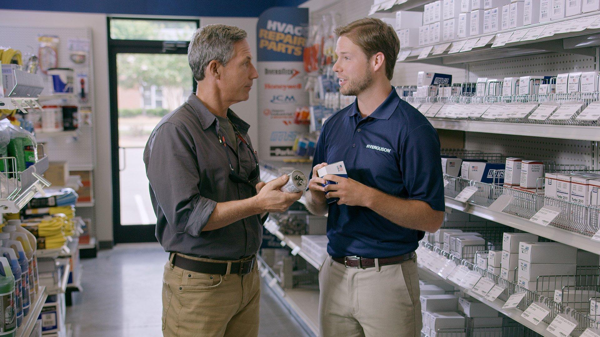 An associate discusses a capacitor with a customer at a Ferguson location.