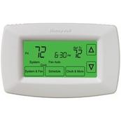 A white programmable thermostat with green-it screen.