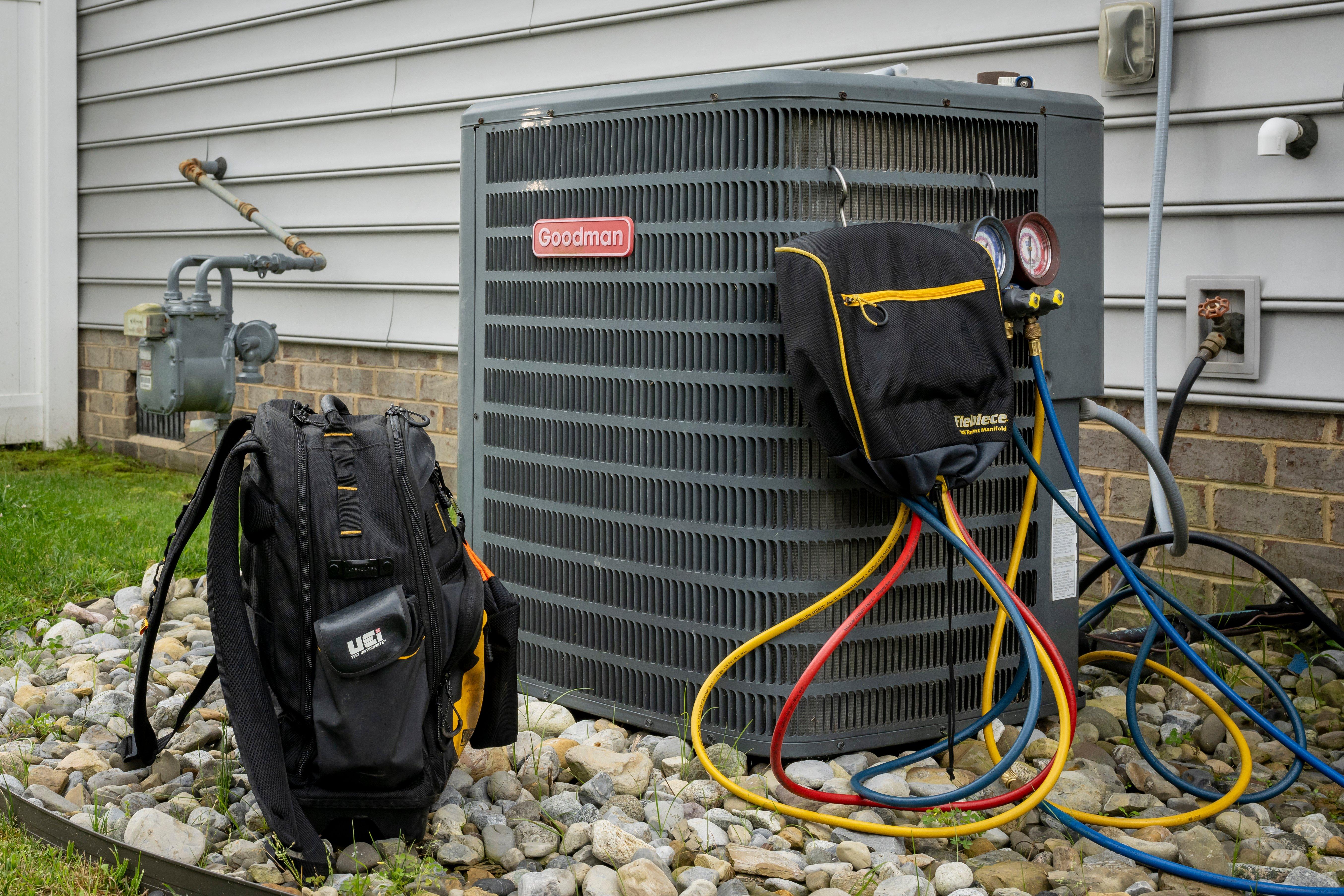 A2L tools and parts are connected to a residential AC condenser.