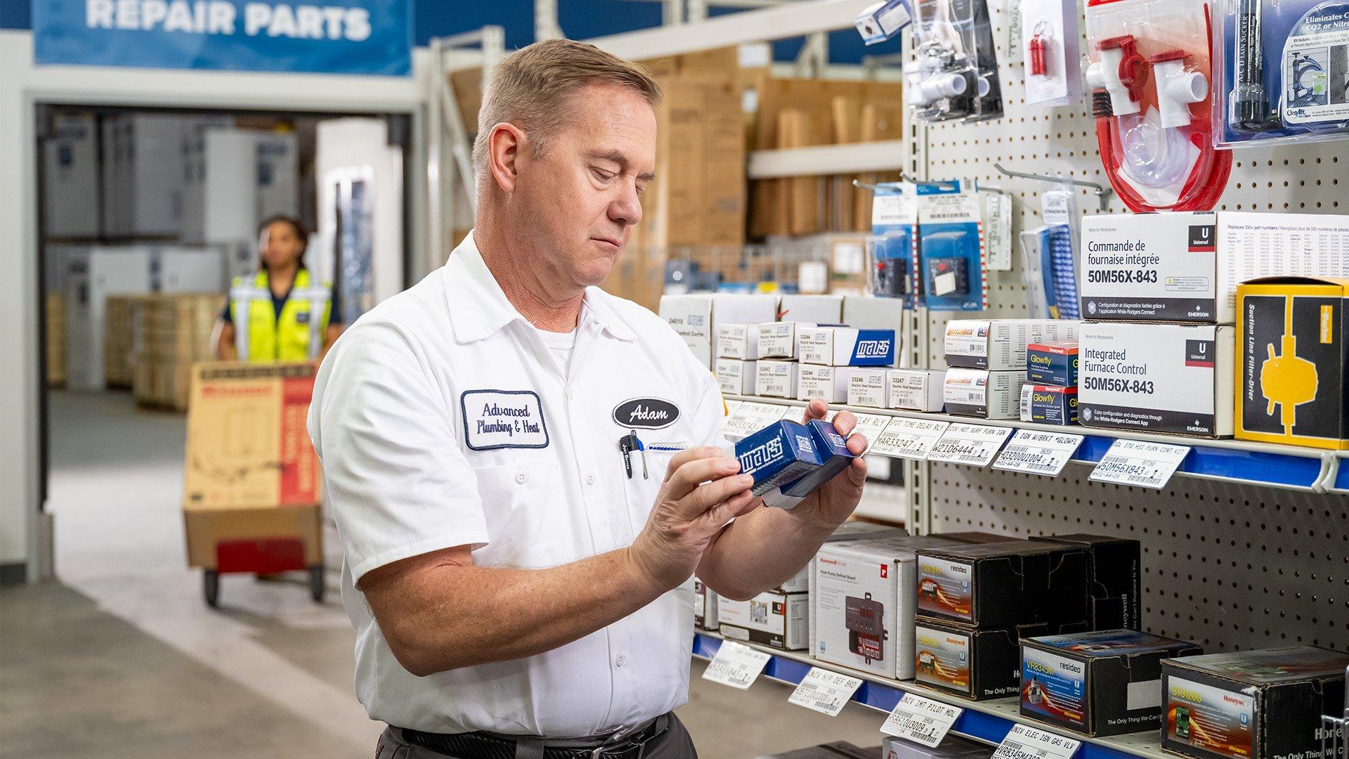 Customer shops HVAC parts in Ferguson counter. 