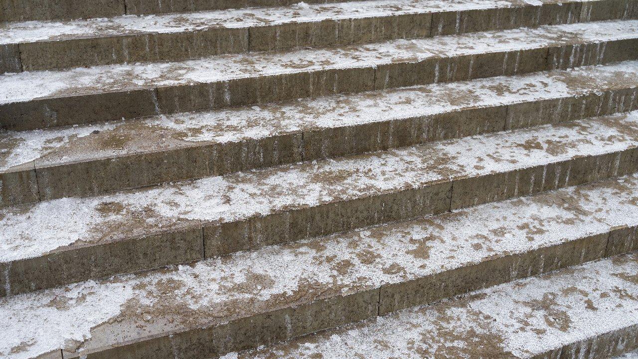 Ice covers concrete steps outside.