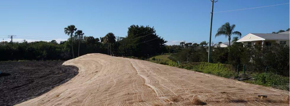 In a rural neighborhood, geogrid is used to reinforce compacted soil.