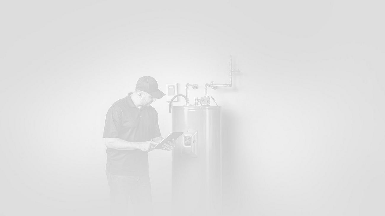 Technician works on residential water heater. 