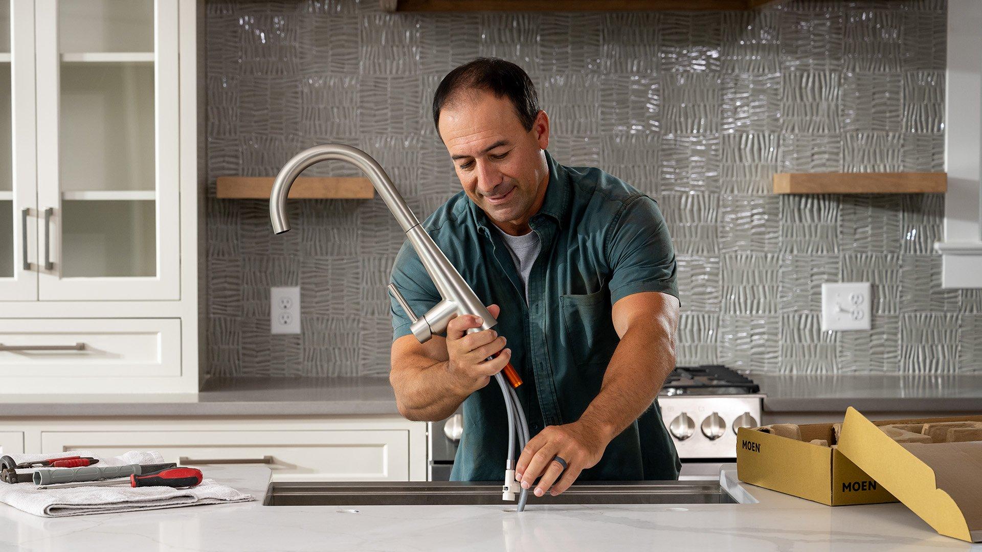 Lifestyle image of stainless steel double basin sink with kitchen faucet.