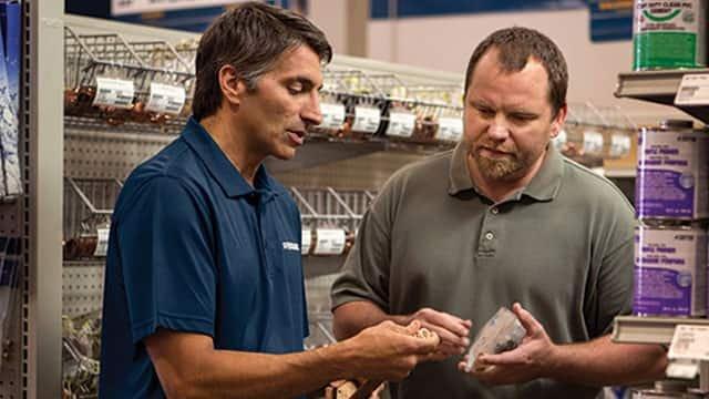 An associate discusses a product with a contractor at a Ferguson counter location.