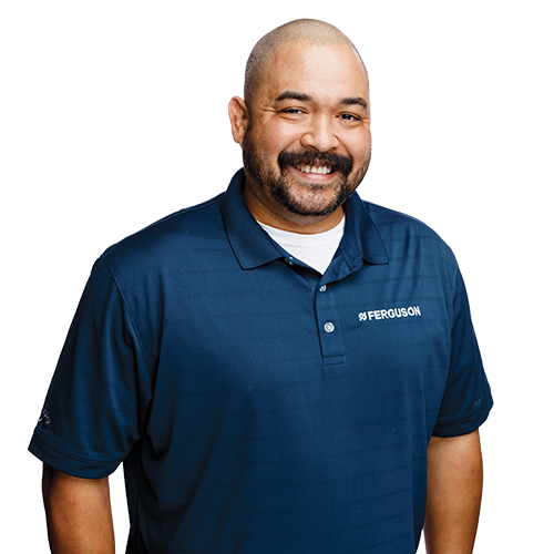 A silo image of smiling Ferguson employee in blue polo shirt.