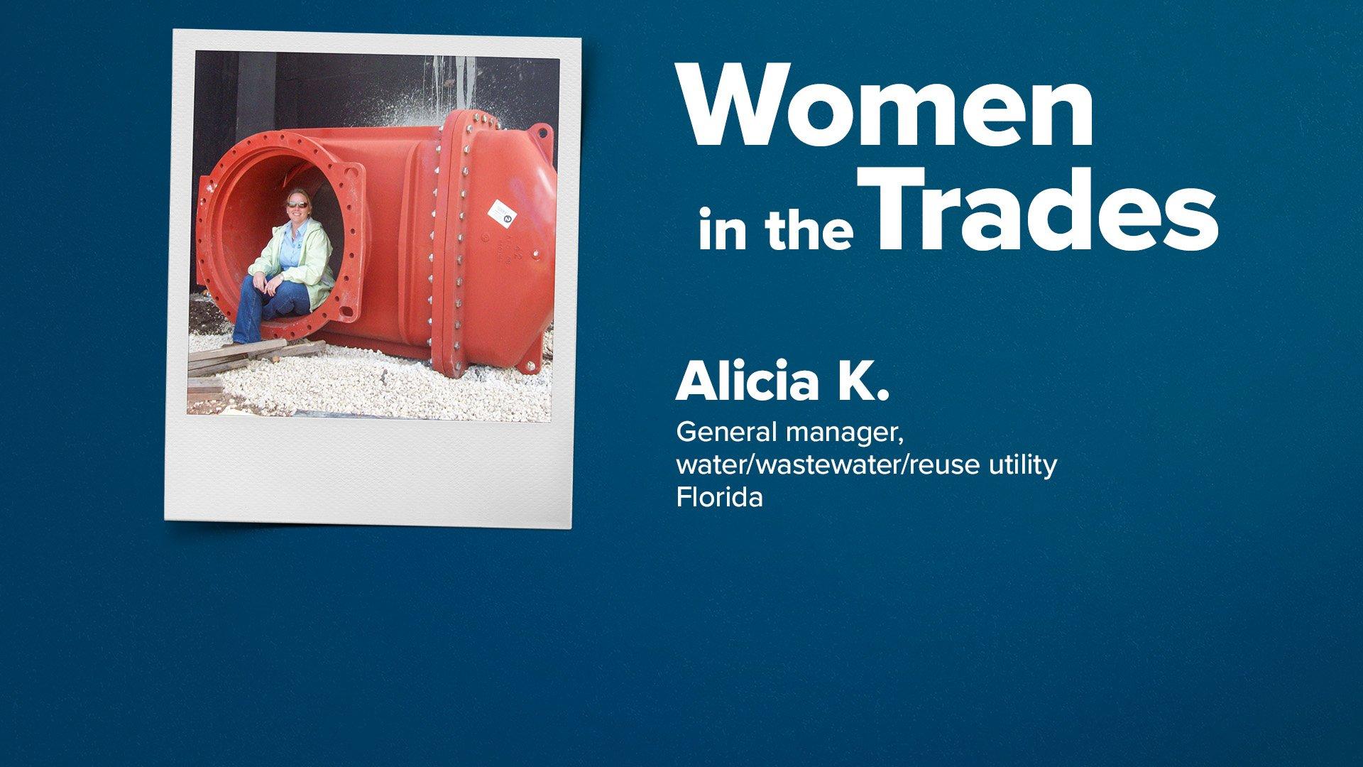 Alicia Keeter sits in the opening of a large, red underground water pipe connector.