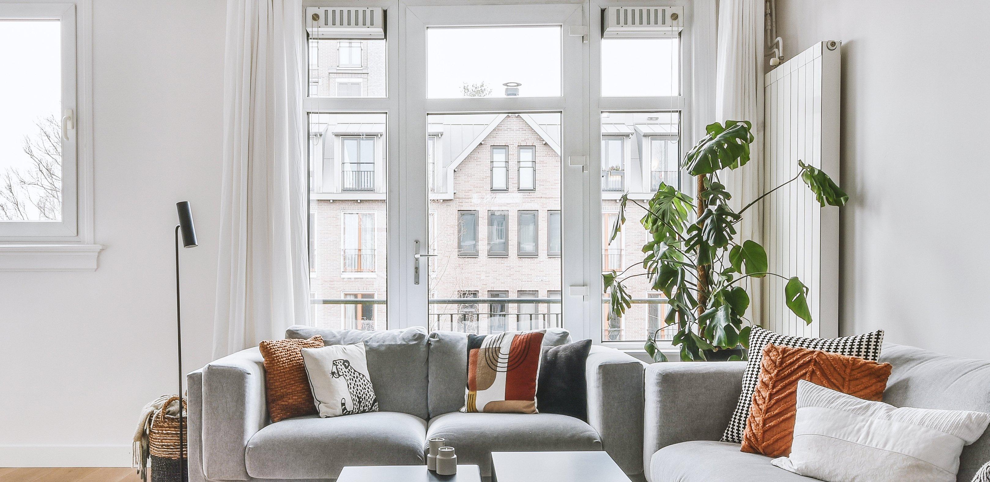 View of a modern apartment living room with IAQ solutions on windows.