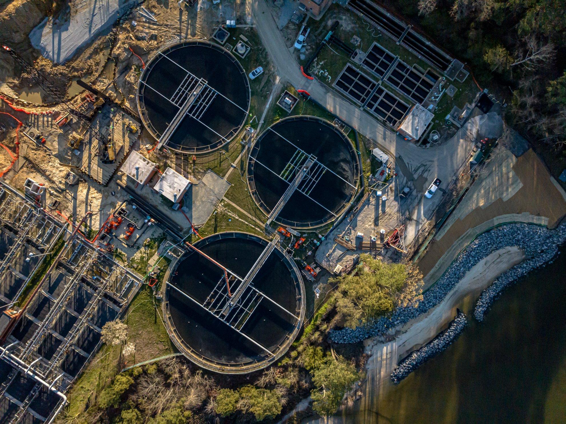 View from above of three reservoirs at a water treatment plant.